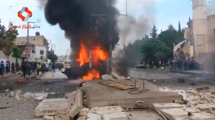 снимка : A still image taken from a video posted to a social media website said to be shot on May 3, 2017, shows what is said to be the site of a car bomb in what is said to be Azaz, Syria. Social Media Website via Reuters TV